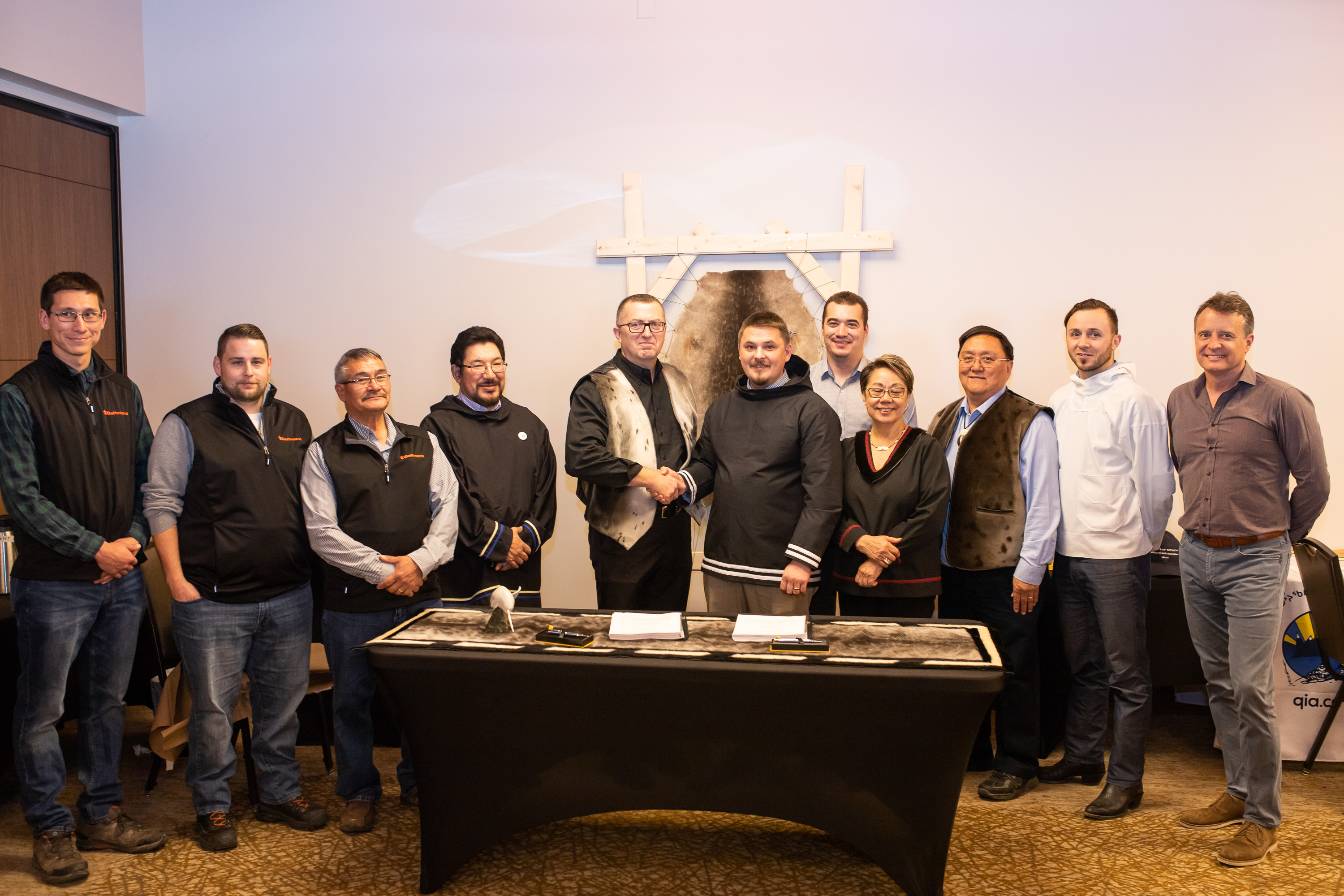 Baffinland Iron Mines Corporation President and CEO Brian Penney (center left) is pictured with P.J. Akeeagok, President of the Qikiqtani Inuit Association, following the signing of the Amended Mary River Project Inuit Impact Benefit Agreement.